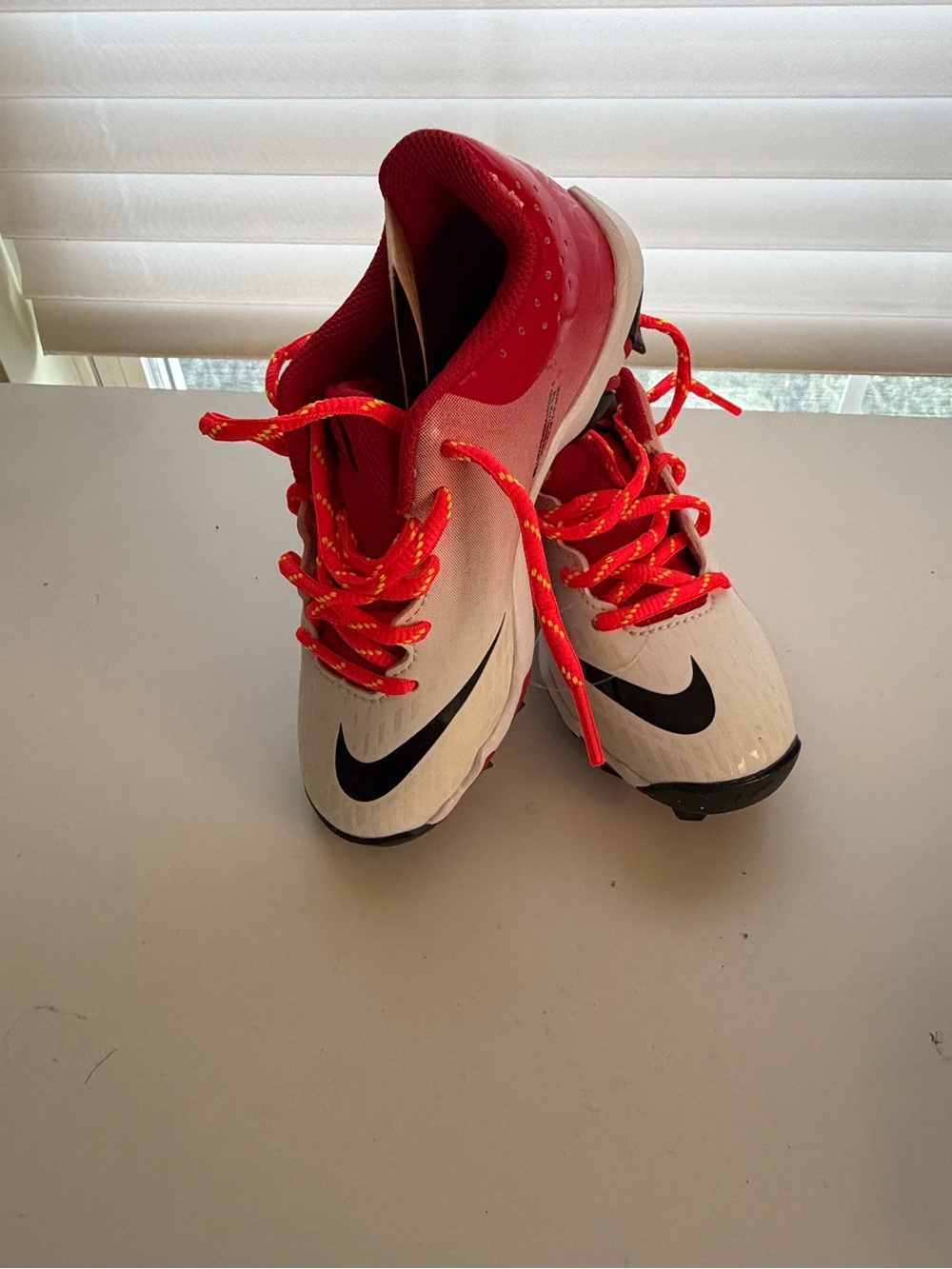 Nike Kids White and Red Cleats with Black Swoosh